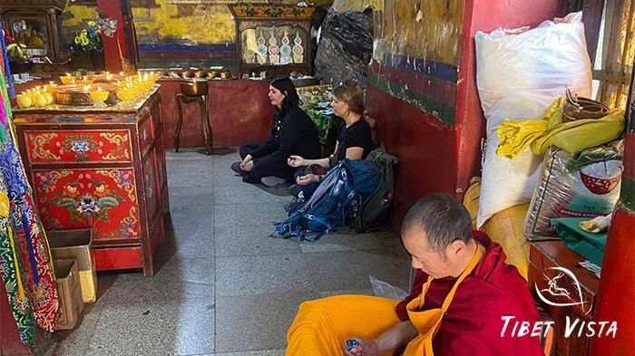 Our beloved guests meditate inside the Tibetan monastery